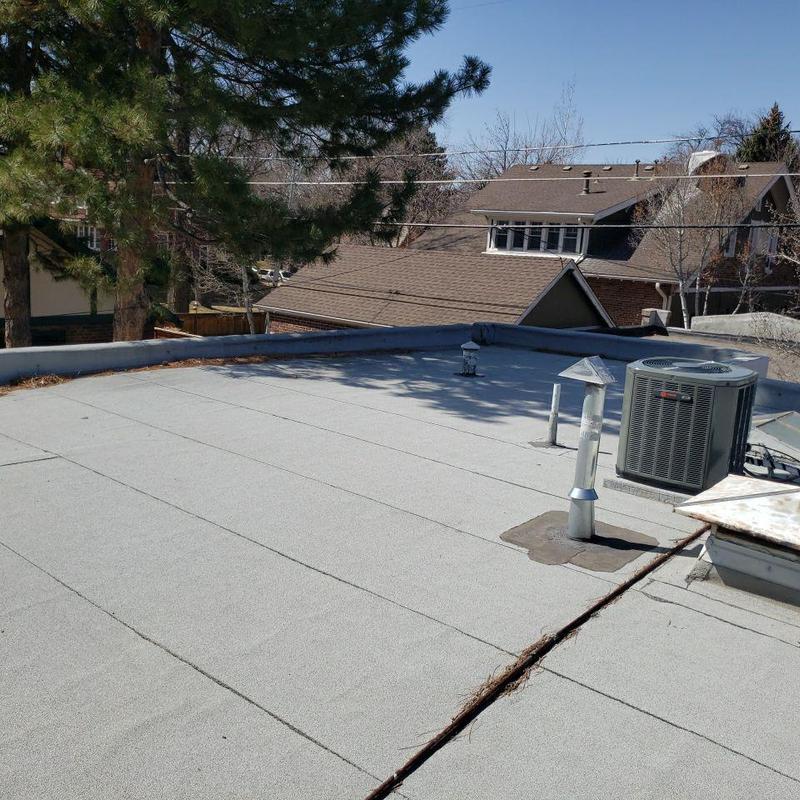 Flat roof with pipe jacks and HVAC unit inspection