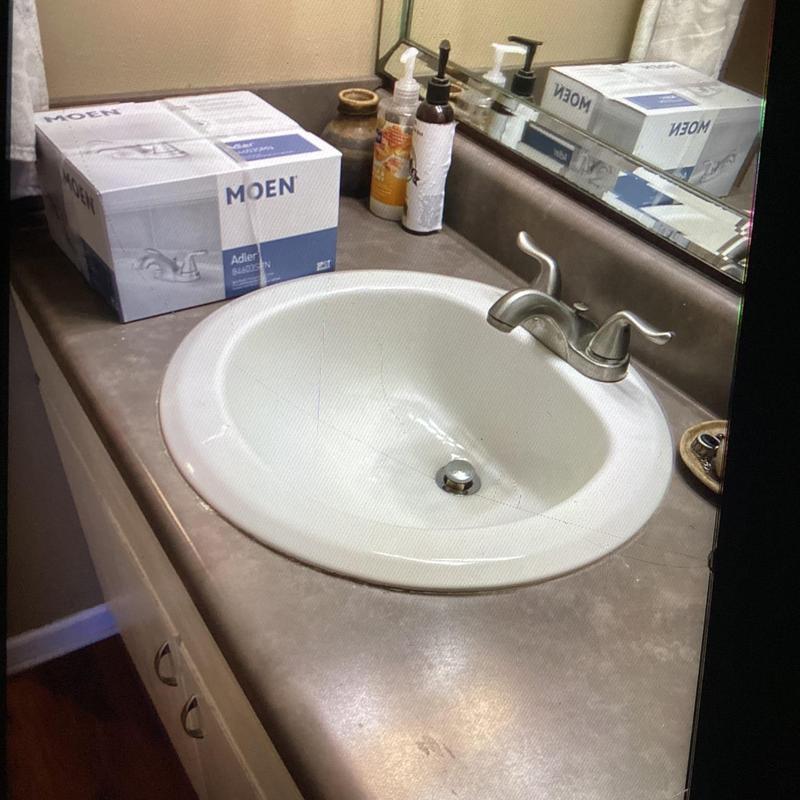 Bathroom sink faucet with Moen faucet box on countertop