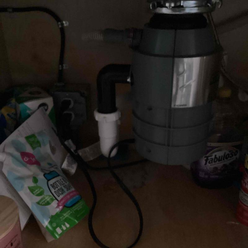 Garbage disposal installation under kitchen sink