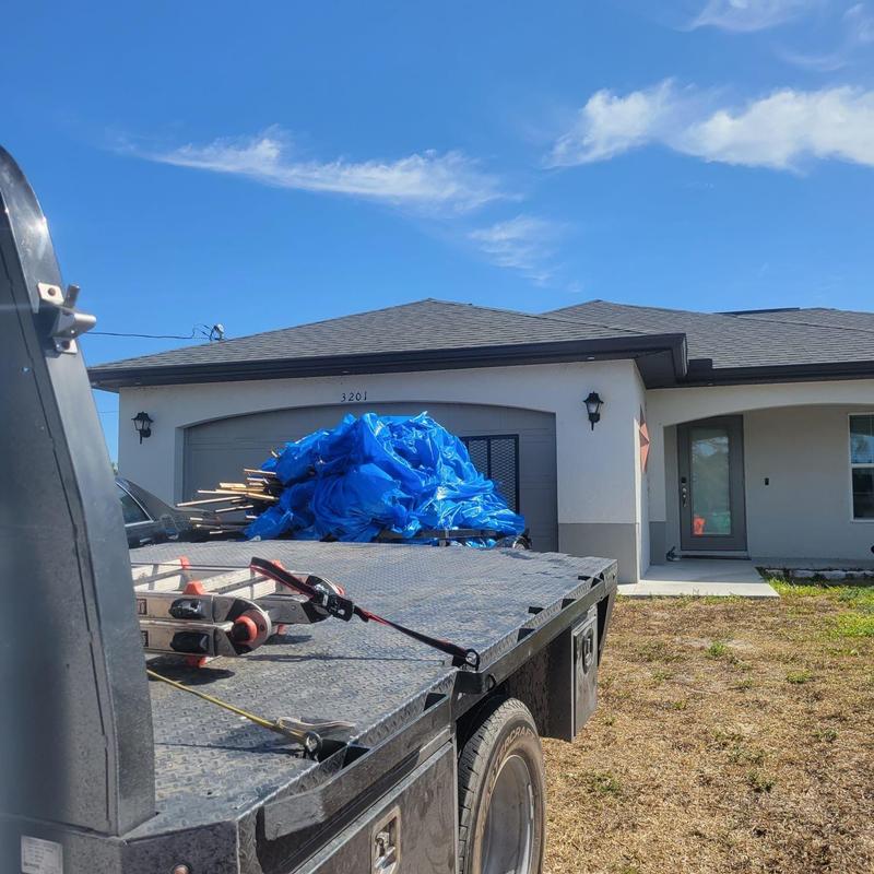Shingle roof with repaired hip and eave damage