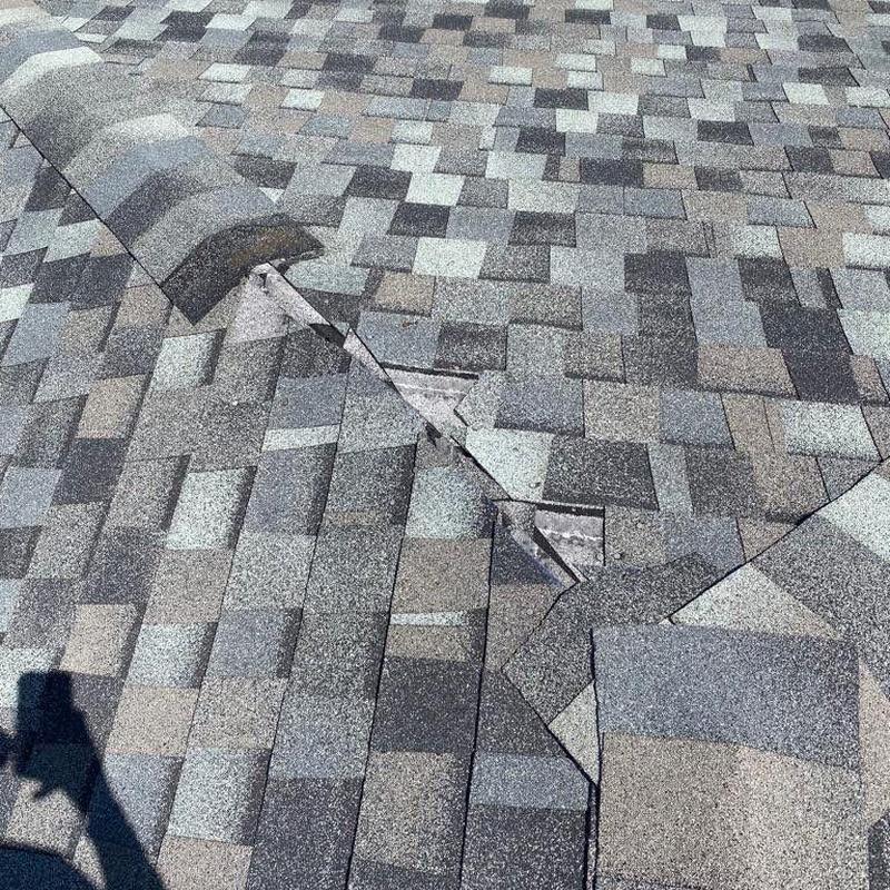 Hip cap shingles with color mismatch on roof surface