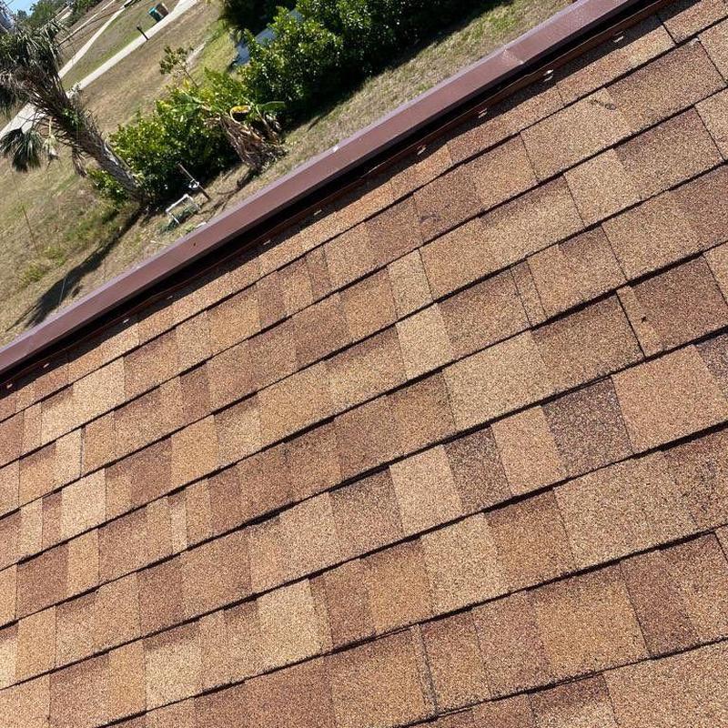 Shingle roof with repaired damaged area and new shingles