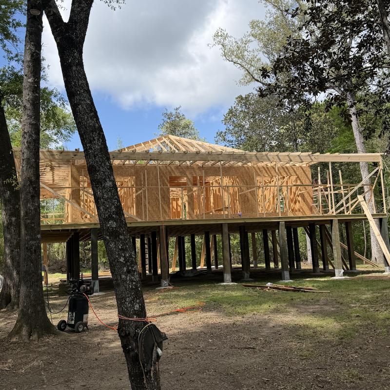 Wooden roof framing on raised house construction site