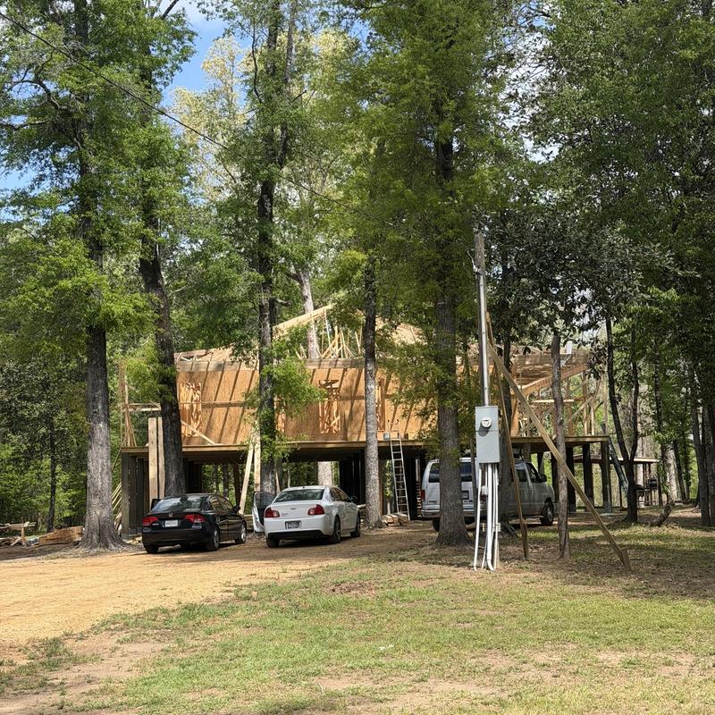 Wood framing new construction under trees in Florence, MS