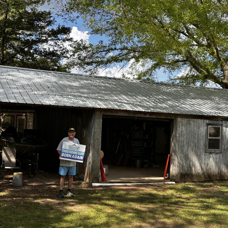 Metal roofing installation on rustic building exterior