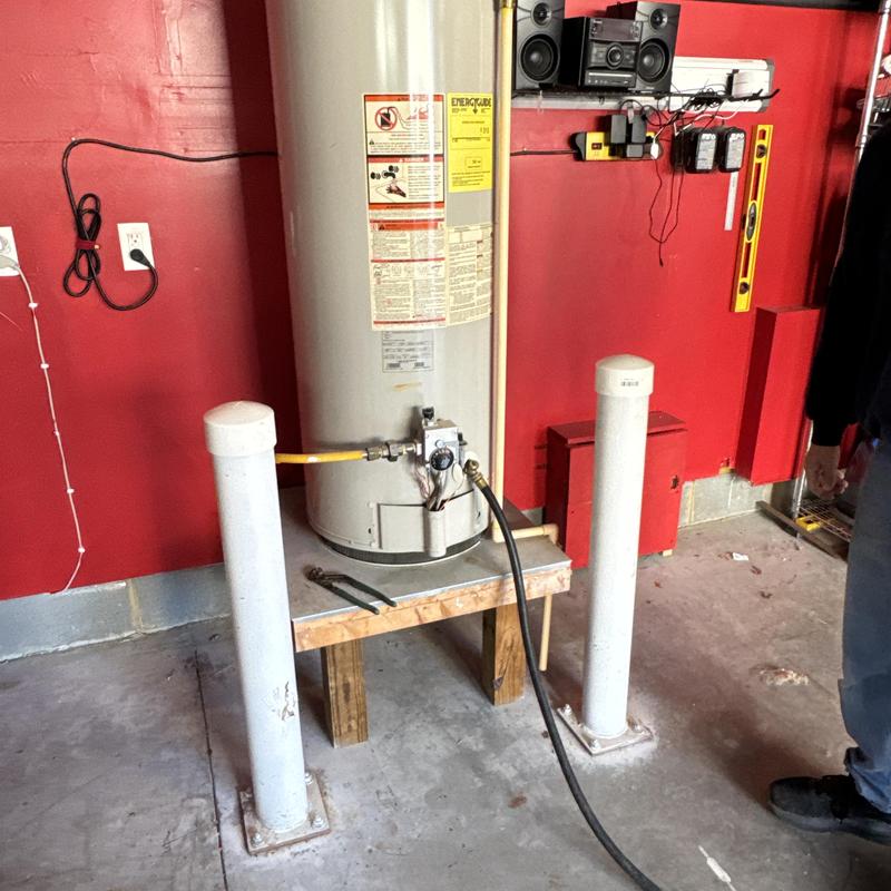 Gas water heater installation on raised platform
