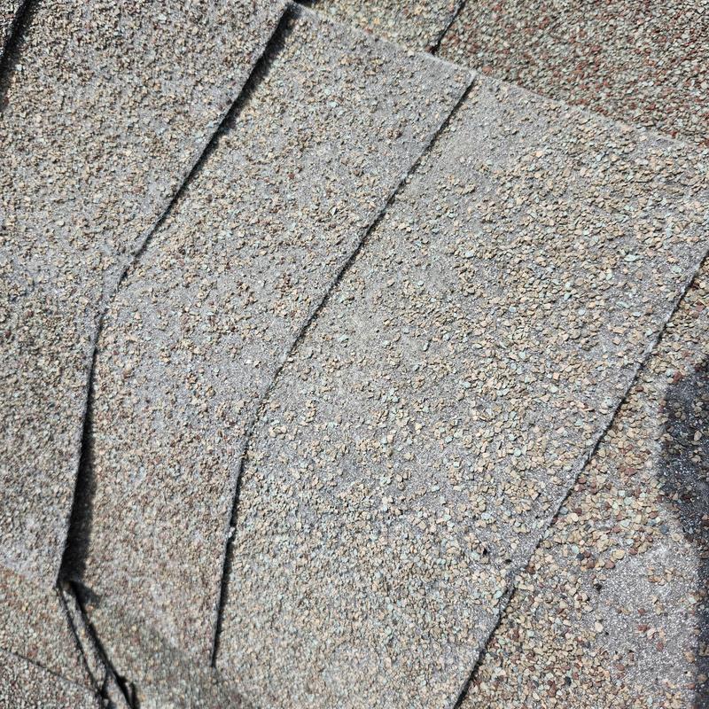 Old asphalt roof shingles with granular loss