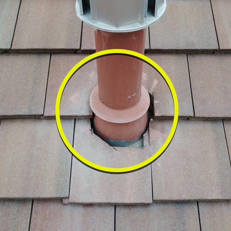 Tile roof pipe jack with broken surrounding tiles