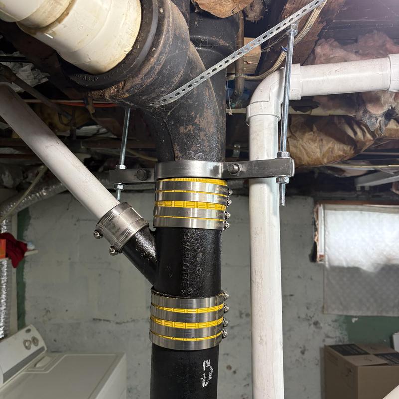 4-inch cast iron waste main with new PVC fitting