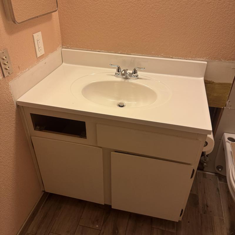 Bathroom sink and countertop with faucet installed