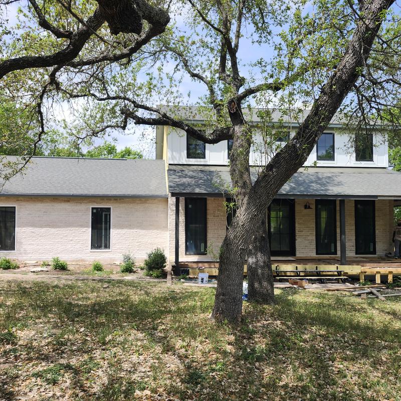 Metal standing seam roof with new glass skylight installation