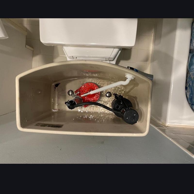 Toilet tank with replaced flapper and fill valve parts