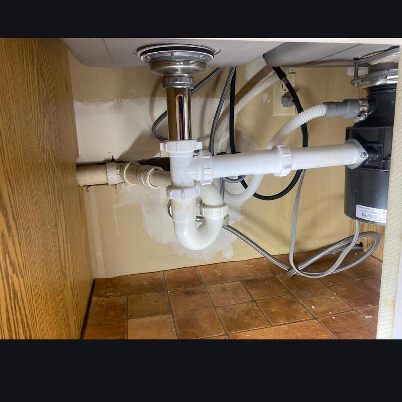 Kitchen sink drain pipes and disposal installation under sink