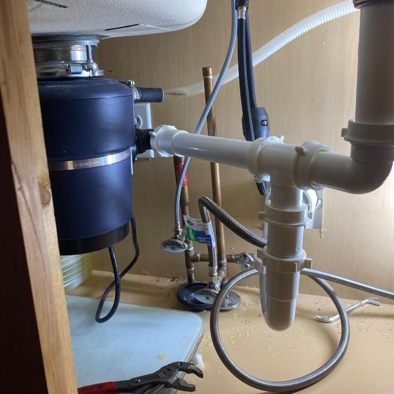 Garbage disposal and sink drain plumbing installation under cabinet