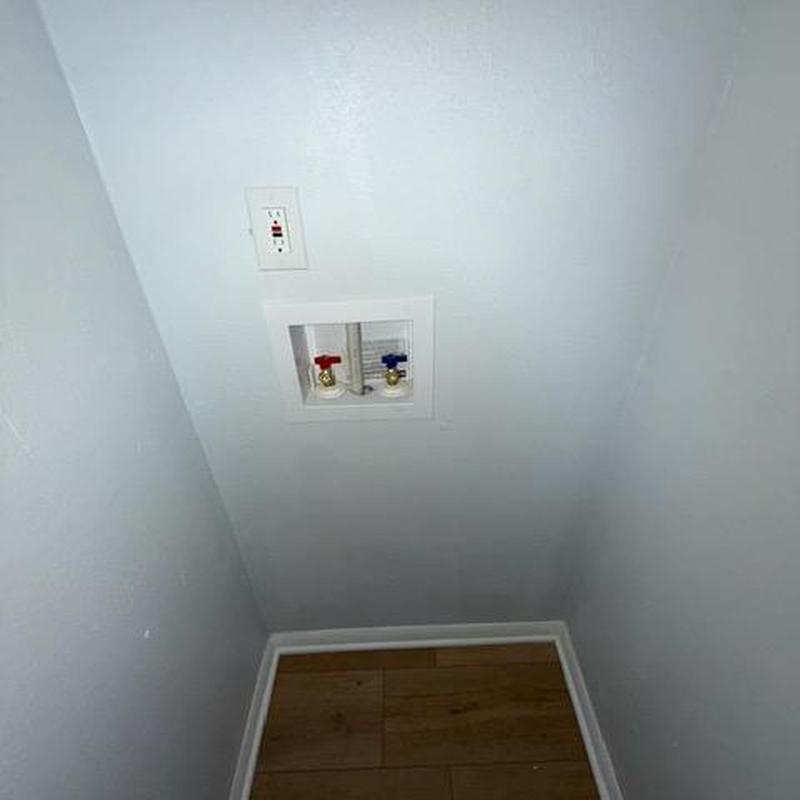 Washer box with hot and cold valves on wall