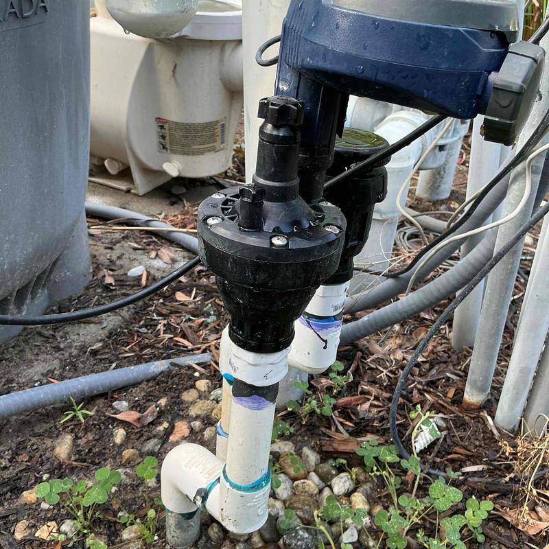 Pool fill valve with attached piping outdoors