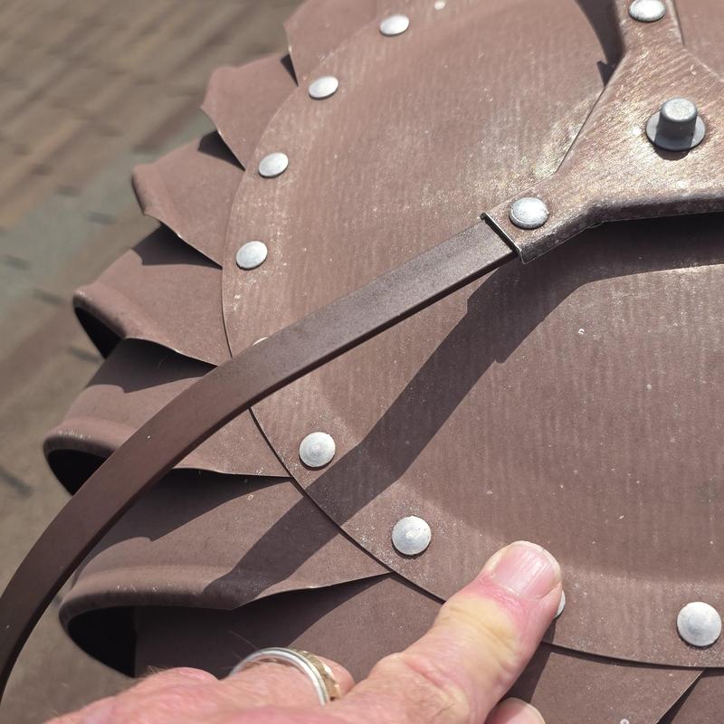 Roof turbine vent with metal rivets and dents