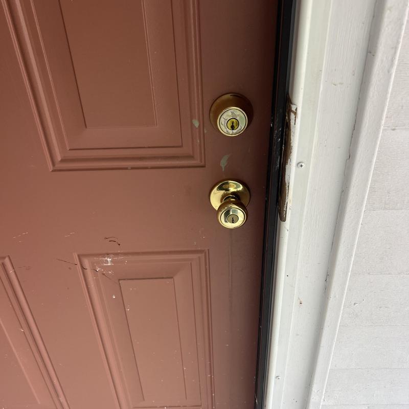 Door deadbolt and knob lock on brown house door
