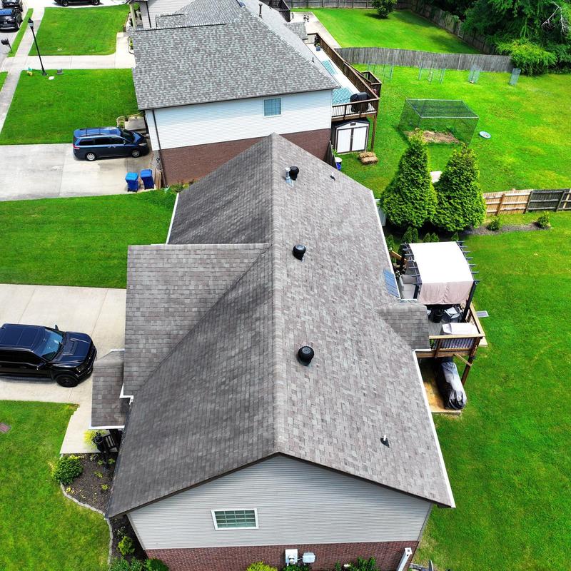 Asphalt shingle roof with vents and adjacent homes
