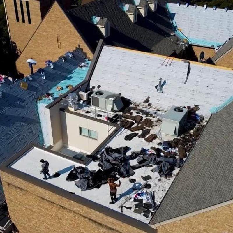 Commercial flat roof with HVAC units inspection and debris