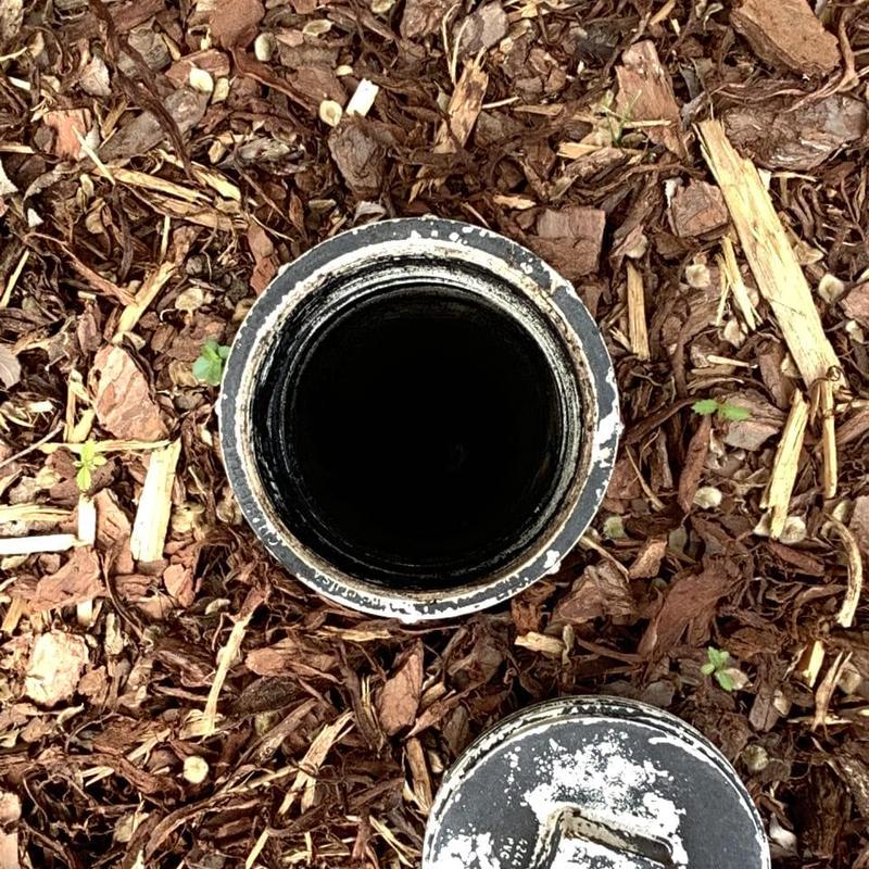 Grease trap line access pipe in mulch bed