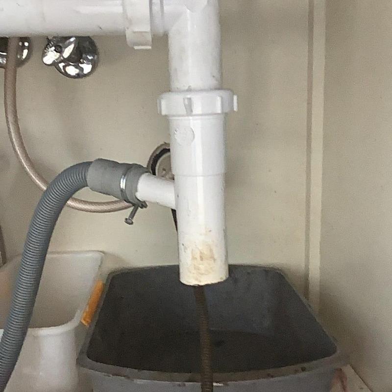 Kitchen sink PVC drain pipe installation under sink