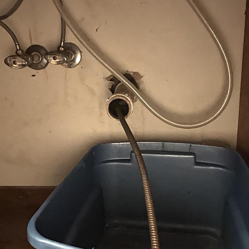 Kitchen sink drain with cleaning snake and catch basin