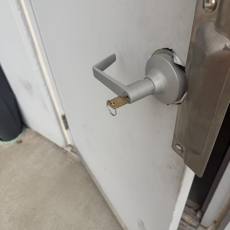 Outside lever trim with key on metal door lock