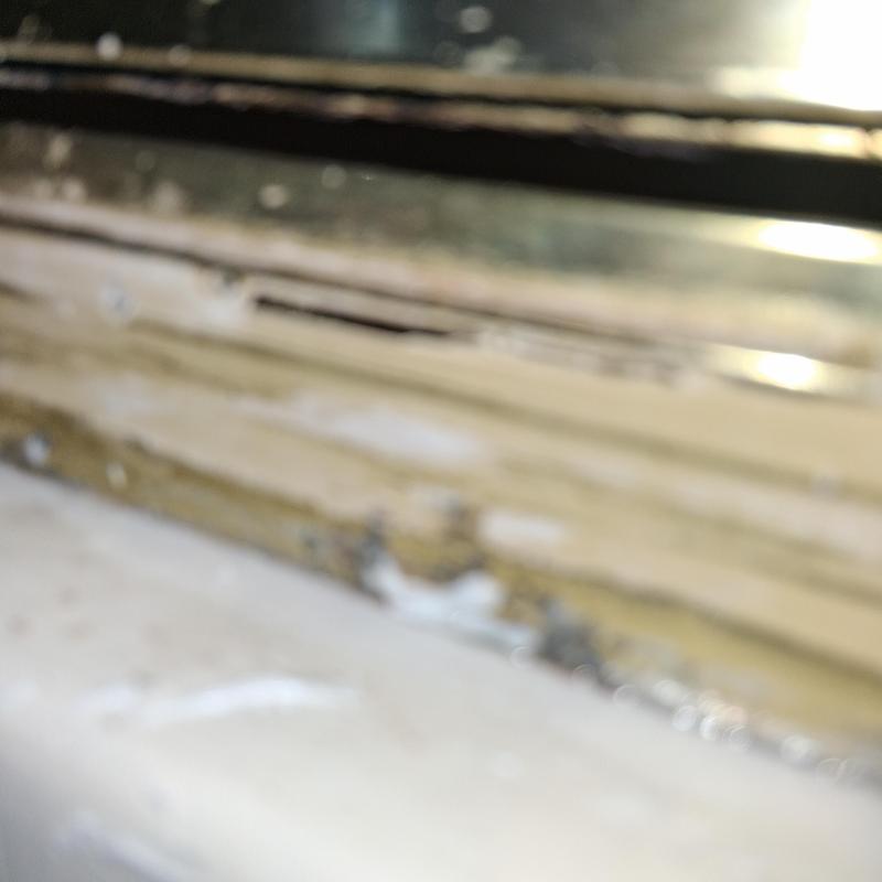 Shower caulk and quarter round removal close-up