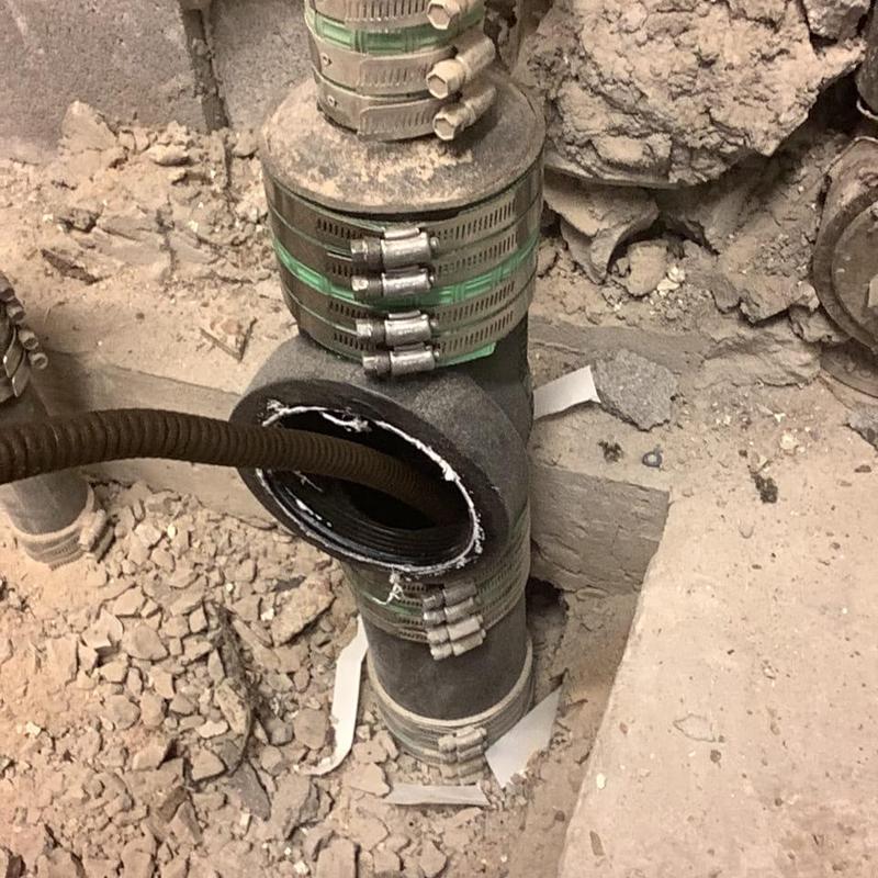 Main sewer line pipe with cleaning snake inserted