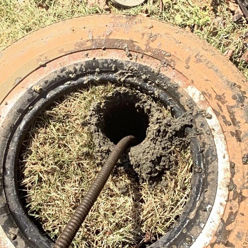 Main sewer line with cleaning auger in grassy area