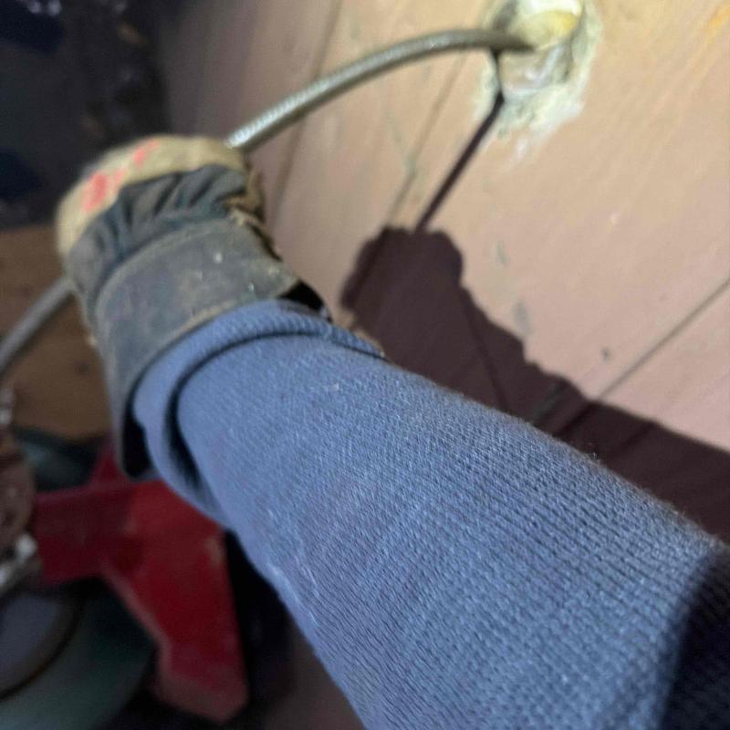 Mainline drain cable entering exterior wall cleanout