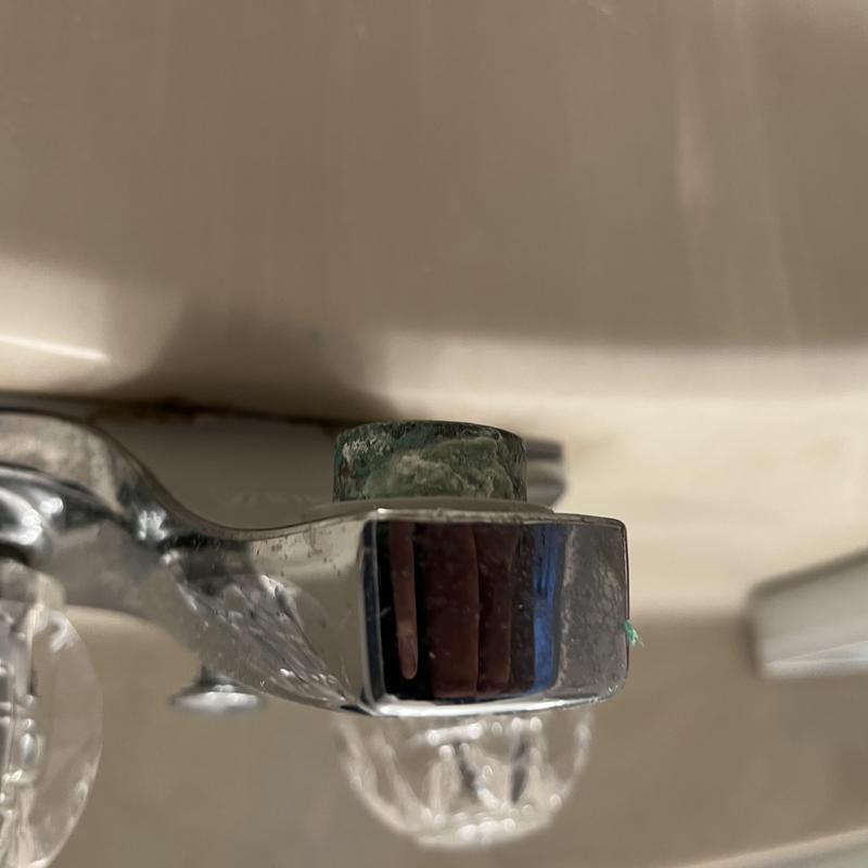 Lab faucet handle with corrosion buildup close-up