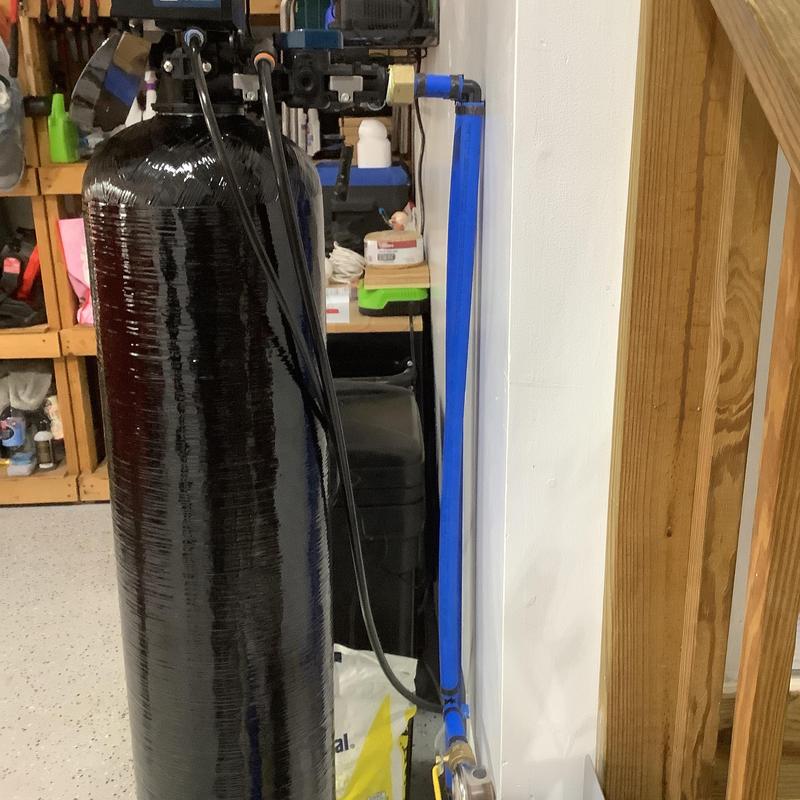 Water softener tank and plumbing installation setup