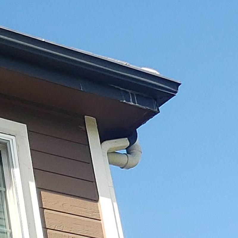 Gutter corner with leak near tile roof edge