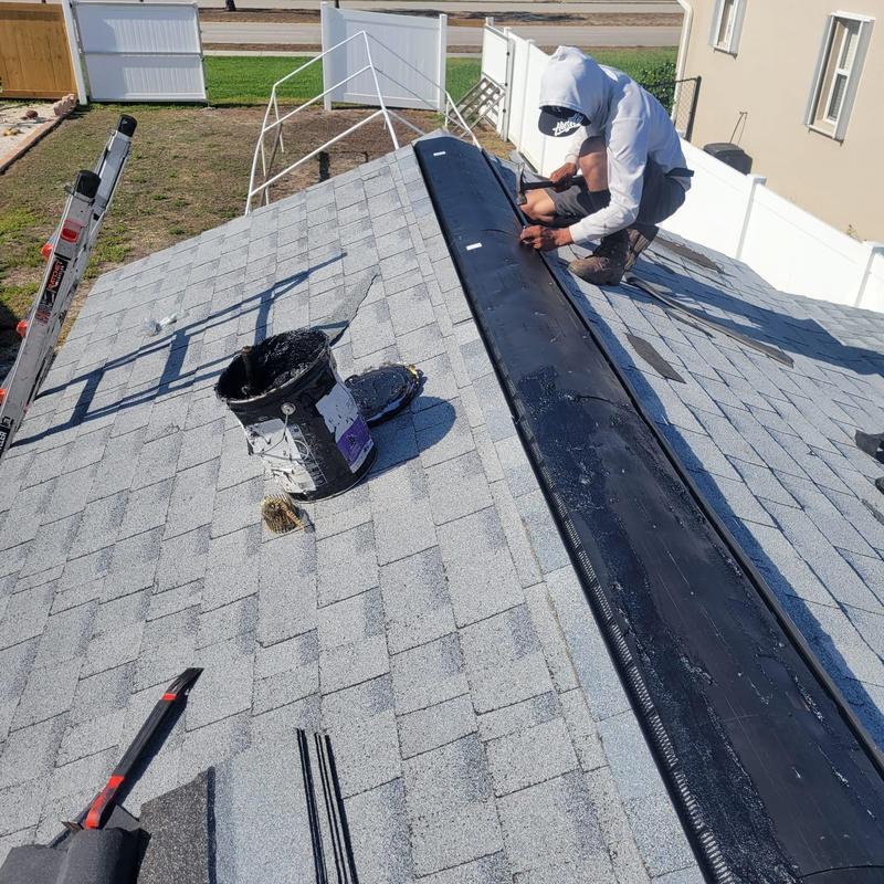 Shingle ridge vent installation on asphalt roof