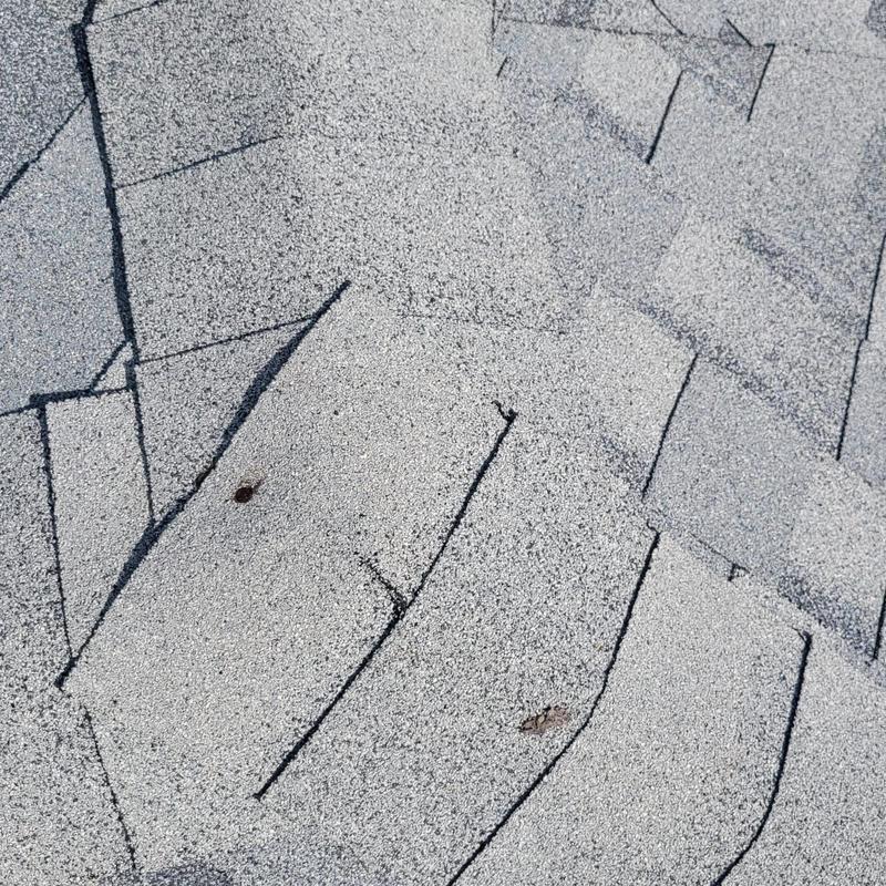 Shingle ridge vent with repaired shingles and sealing