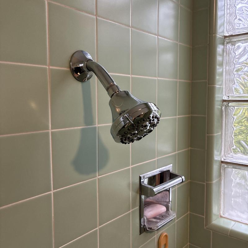 Shower head replacement and soap holder in tiled shower