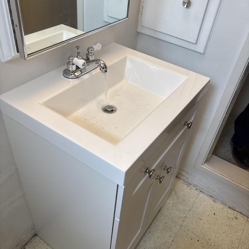 Bathroom vanity sink with faucet running