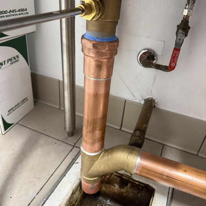 Copper floor drain pipe installation with valve connections