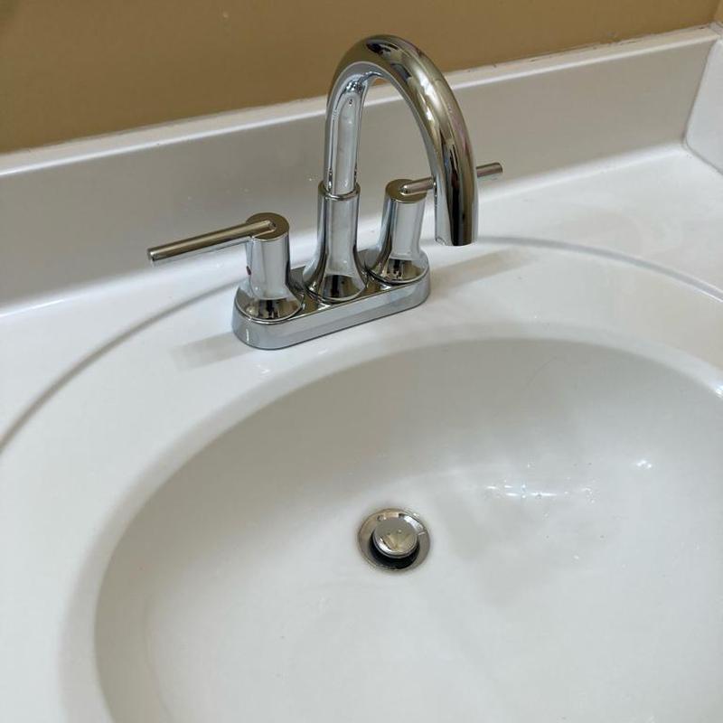 Bathroom sink faucet and pop-up drain assembly installed
