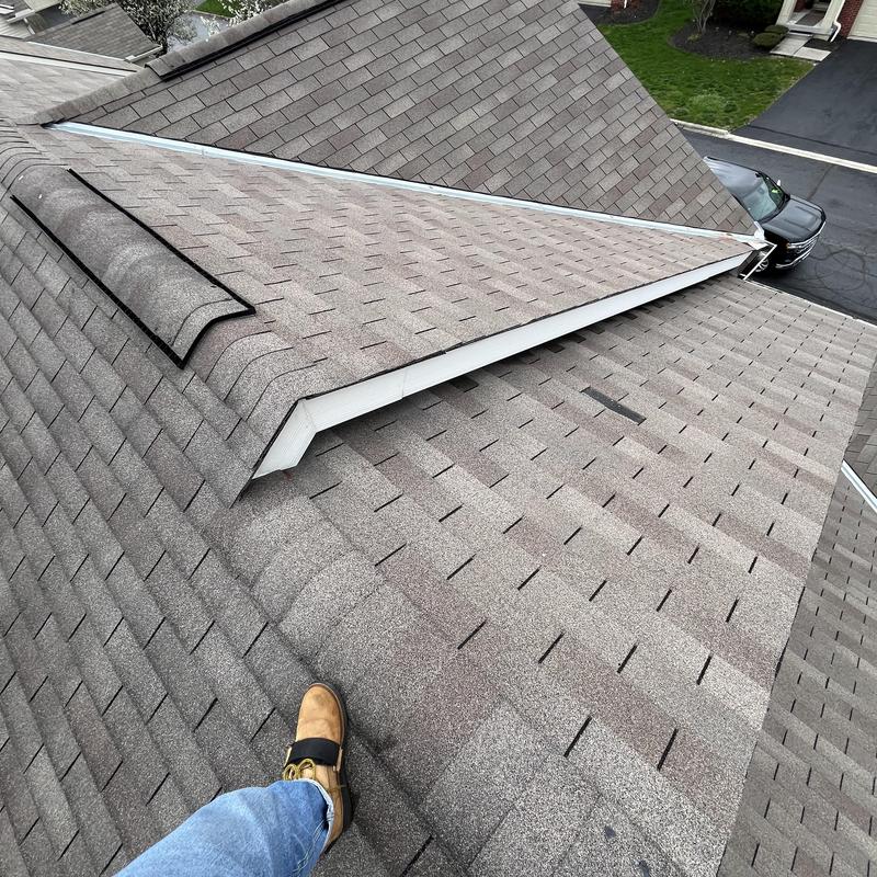 Asphalt shingle roof ridge with vent and repairs Asphalt shingle roof ridge with vent and repairs