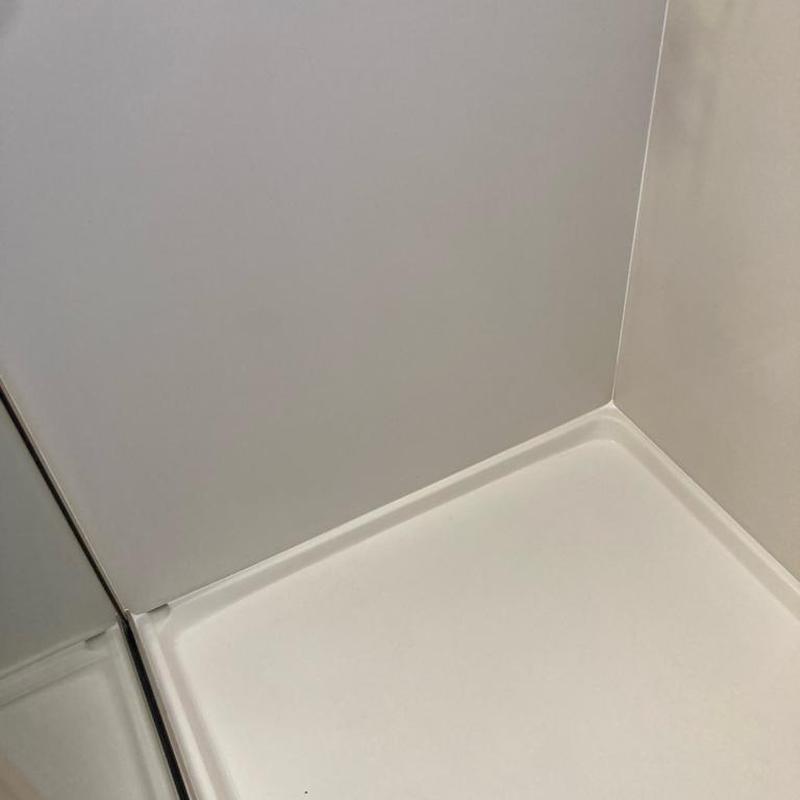 Master shower base and wall cleaned and recaulked