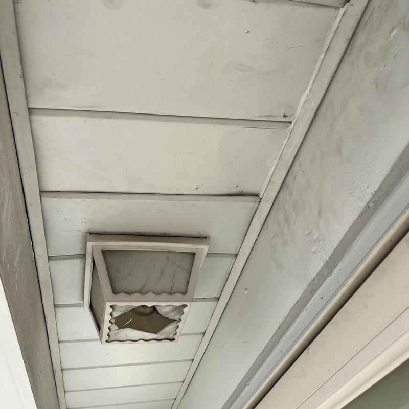 Soffit panels with broken outdoor light fixture, white Soffit panels with broken outdoor light fixture, white