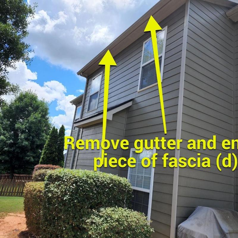 Fascia board replacement behind gutter at house exterior Fascia board replacement behind gutter at house exterior