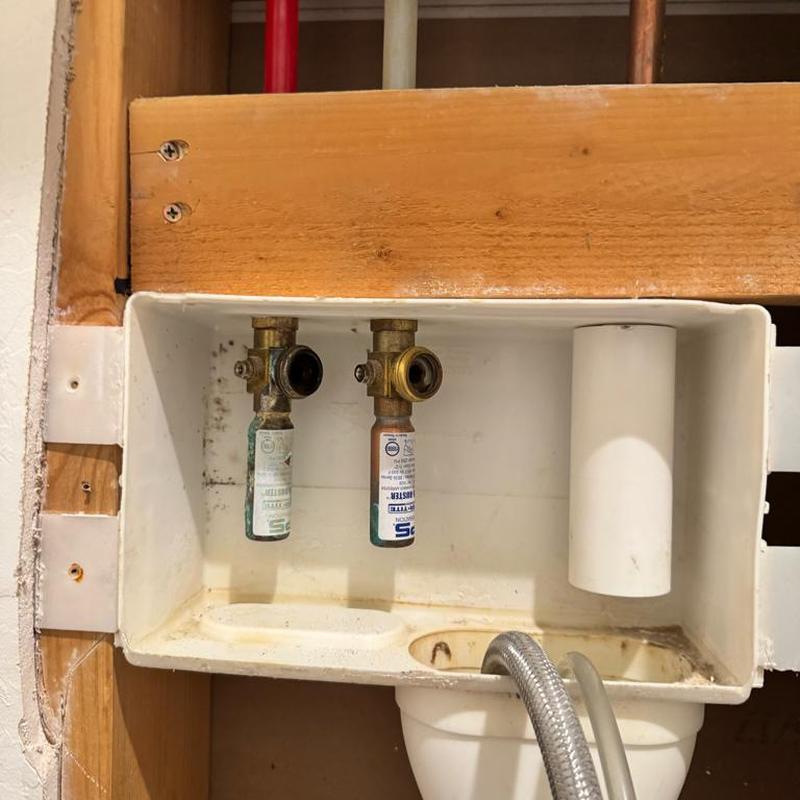 Washing machine valves in drywall box with hose removed