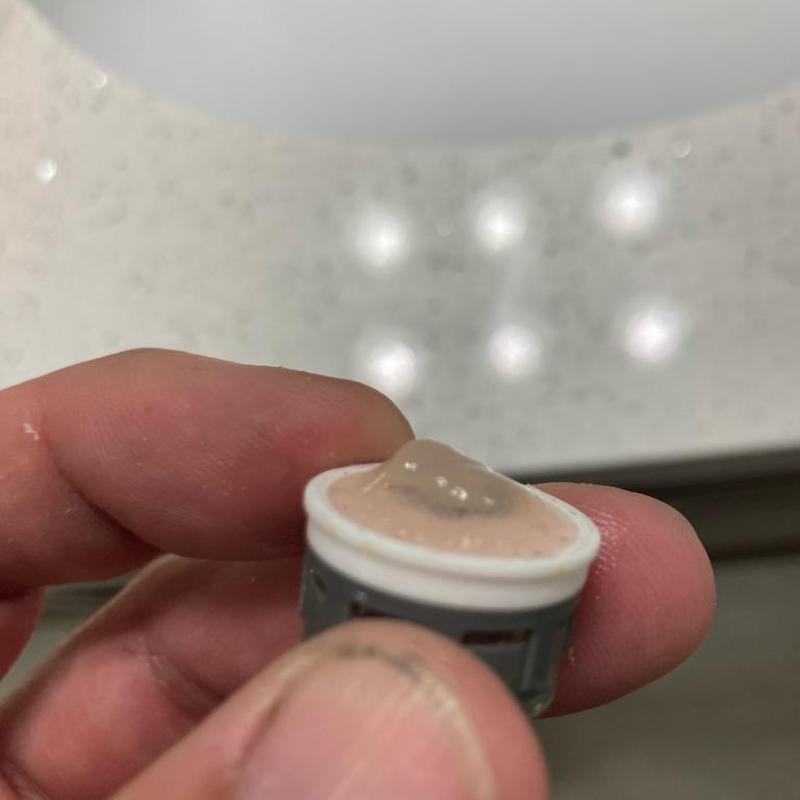 Faucet aerator with mineral buildup in hand Faucet aerator with mineral buildup in hand