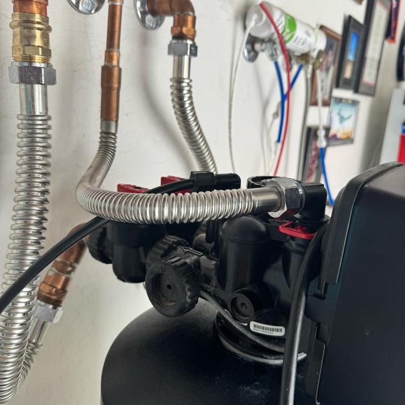 Water softener discharge elbow and flexible connections installation