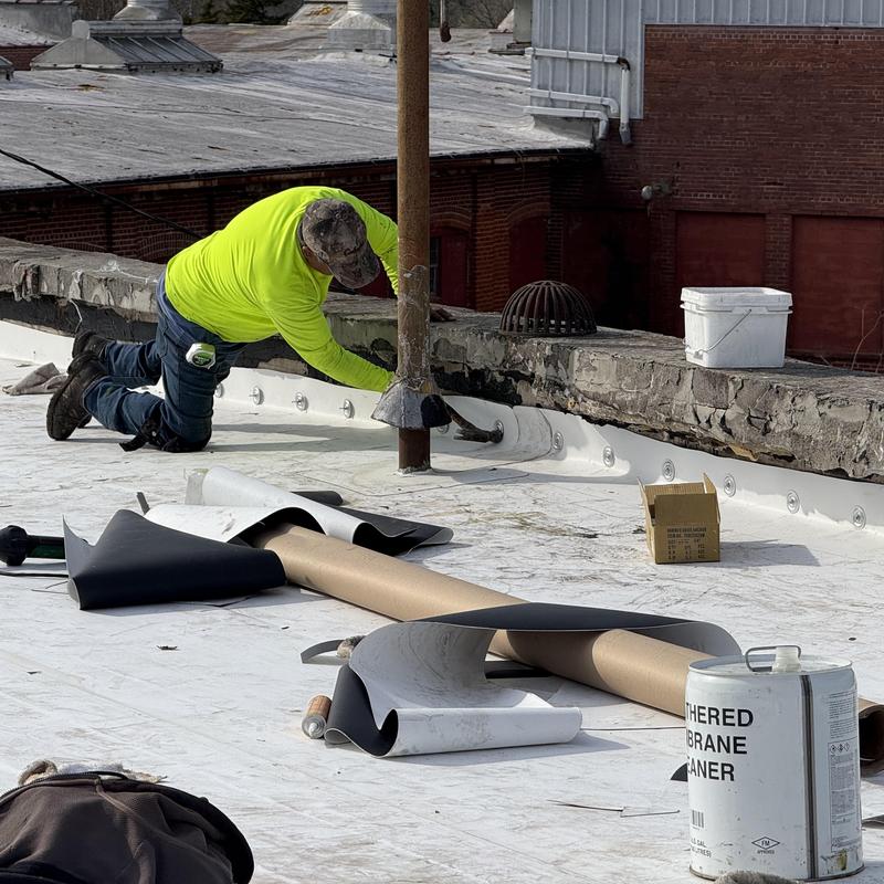 TPO roofing membrane installation on industrial roof edge