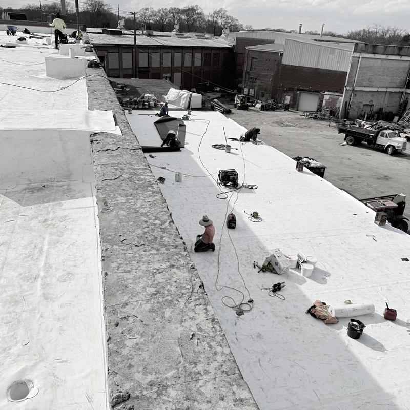 TPO roofing system installation on industrial building